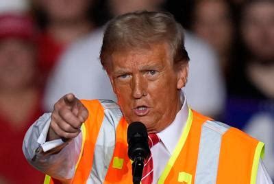 Trump, with a vest and props, turns his attention to trashing Biden 